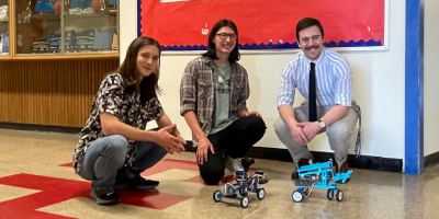 HS students and teacher with robots