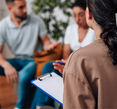 Two people in a counseling session with a counselor