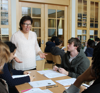 Instructor Ana Ramirez speaking to her students in the archives