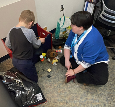 Jay Gomez assists a young client with play therapy