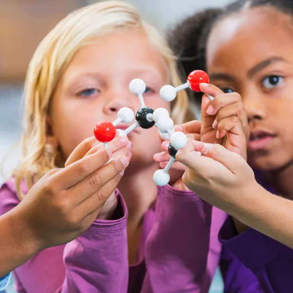 School Children looking at a model of a molecule